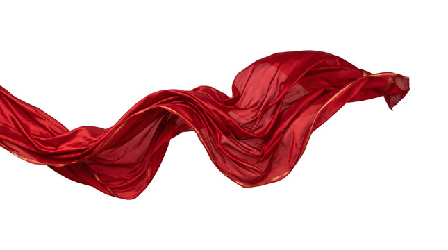 Floating red silk fabric with gold border on black background. Dynamic motion and luxury textile fashion concept.