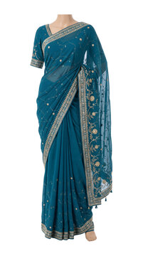 Teal blue embroidered chiffon saree on mannequin. Indian festive fashion and modern ethnic elegance