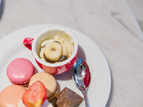 Banana Ice Cream in Red Cup with Macarons