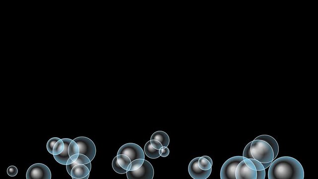 Transparent soap bubbles floating upwards on black background