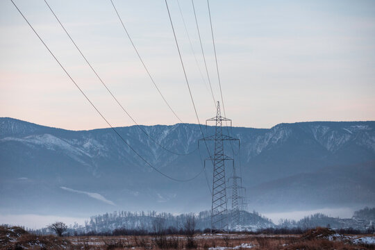 High Voltage Power Lines Against Mountain