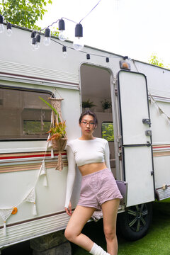 Asian female freelancer traveling in a cozy camper
