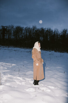 Woman Standing in Snow Field