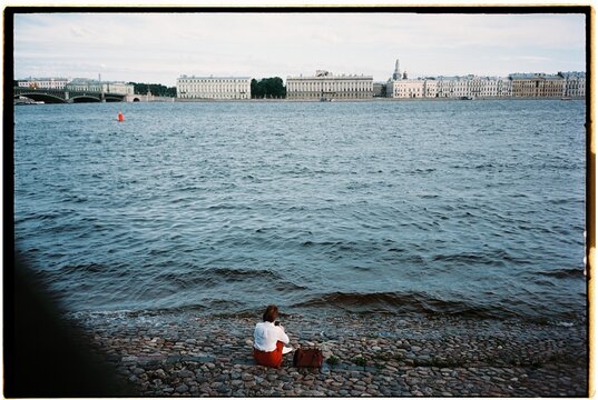 Lonely woman sitting by the river