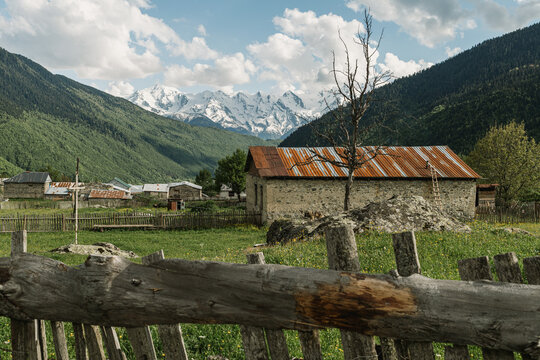 Rustic stone house with snowy mountains