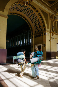 Backpackers at railway station before journey