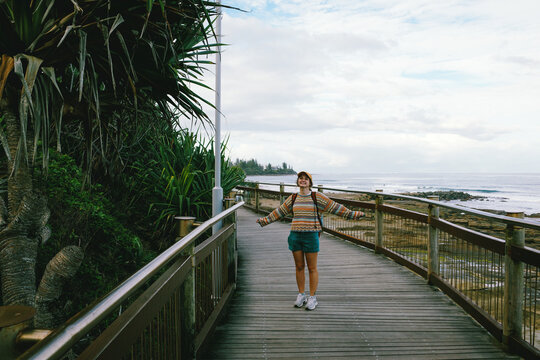 Woman a coastal boardwalk in Queensland
