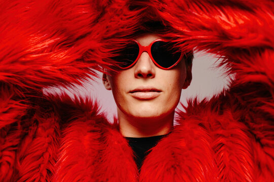 Young man in red sunglasses in shape of hearts