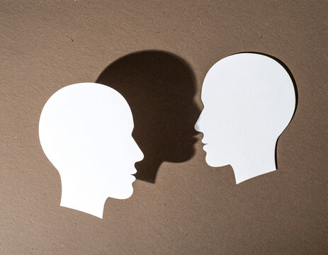 Shadow between two profiles representing unspoken communication