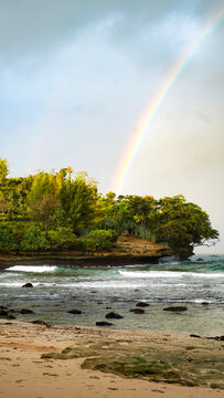 Rainbow Over Tropical Coastal Cliff and Ocean Waves