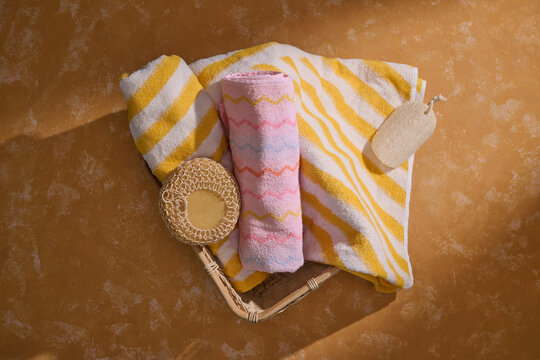 Cozy bath essentials laid out on a textured surface with warm lighting