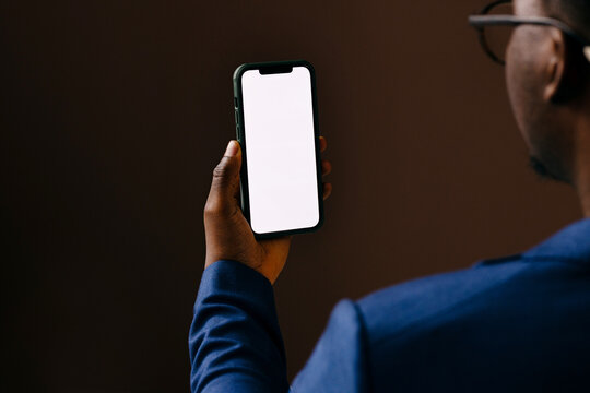 Businessman Holding Smartphone With Blank White Screen