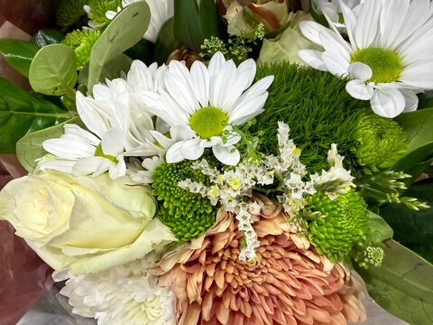 Cream and Orange Roses: A soft floral bouquet featuring white and delicate orange blooms with beautiful cream roses.