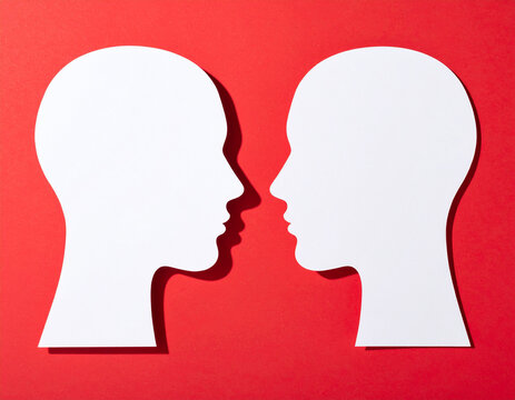 Opposing profiles on red representing intense conversation