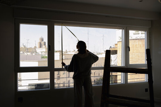 Architect measuring window during apartment renovation