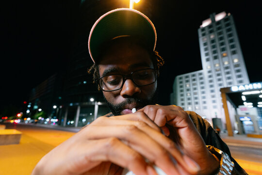 Man Drinking Milkshake at Night