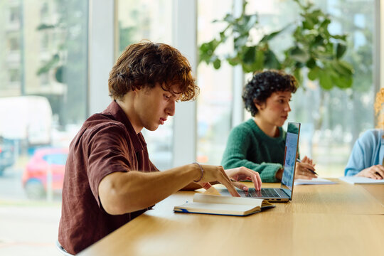 Student is doing research on his laptop