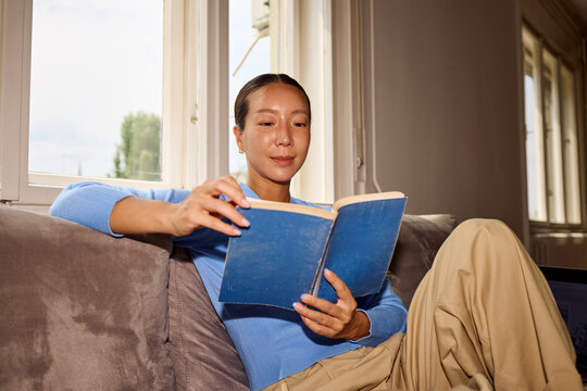 Woman reads indoors