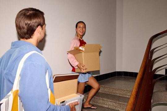Couple ascends the stairs within the building.
