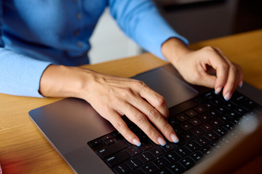 Anonymous person uses laptop keyboard