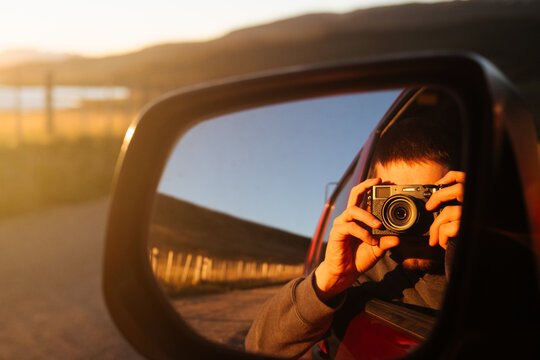 Photographer Reflected in Car Mirror