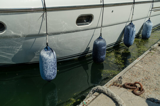 Blue Fenders Along a Boat at the Marina