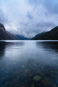 Snowy Peaks Over Alpine Lake