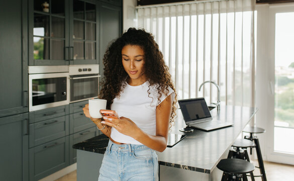 Woman Holding Coffee Checking Phone