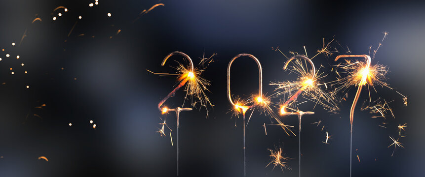numbers 2027 burning sparklers isolated on blurred night background, happy new year 2027 greeting card for new years eve invitation