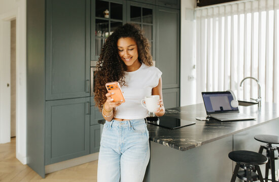 Woman Smiling Holding Coffee By Stool