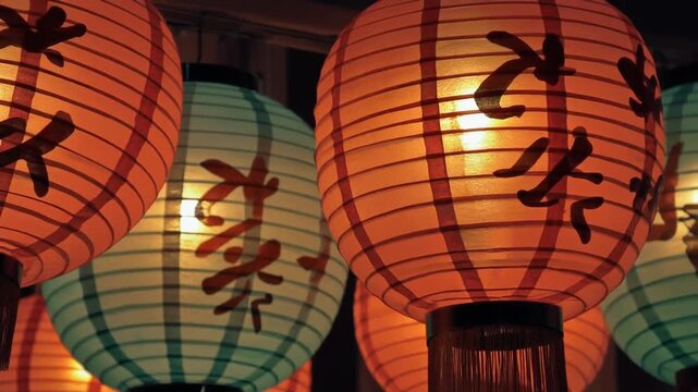 Illuminating traditional Asian paper lanterns adorned with calligraphy create a warm and inviting atmosphere during a festive nighttime celebration, evoking culture and tradition