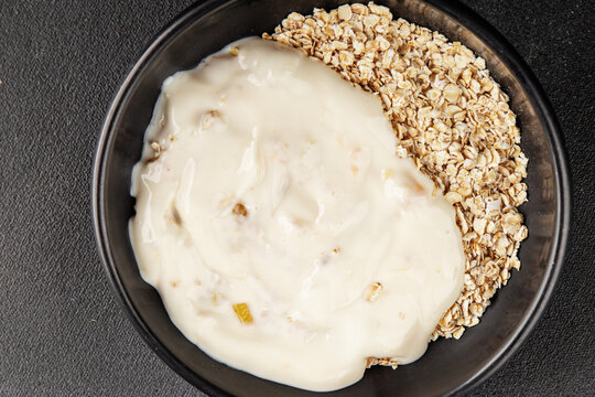 Oatmeal with yogurt healthful breakfast healthy eating delicious snack fresh, gourmet, rustic food background on the table top view copy space keto and paleo diets