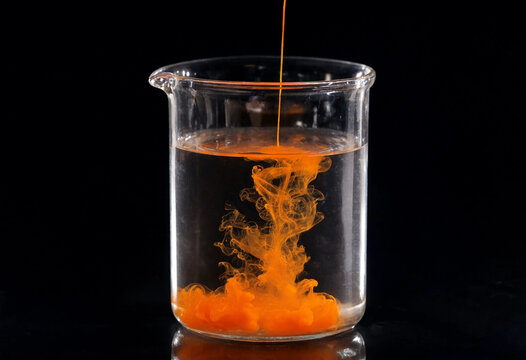 Methyl Orange Indicator Solution Mixing in Glass Beaker on Black Background