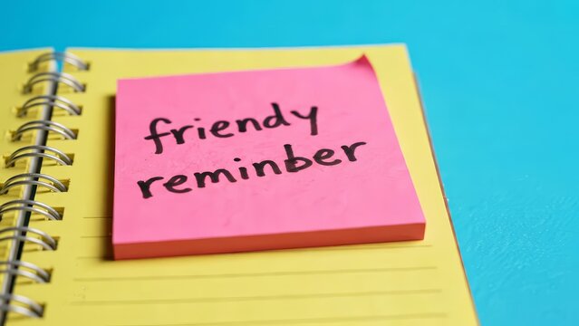 Planning reminder on a pink note attached to yellow office paper with a pink clip.