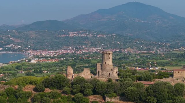 Torre di Velia Elea Velia Italy drone morning archaeological park Cilento Southern Italy, parallax orbit around ancient stone tower, sea mountain background shift, 70mm telephoto compression