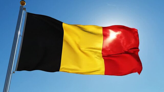 National flag of belgium waving against a clear blue sky