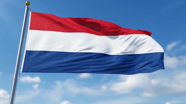 National flag of the netherlands waving against a clear blue sky