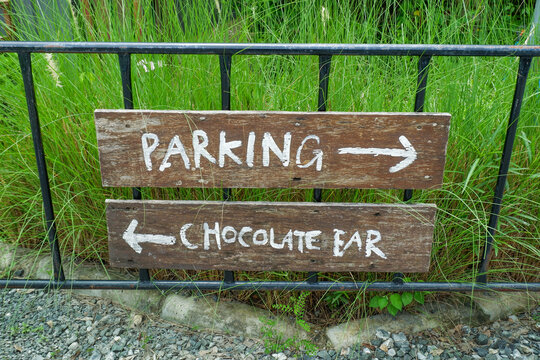 Parking Lot Sign in park,Car Park sign background with white arrow direction,text,streetsign in countryside,public car park information board,vehicle parking area sign concept.