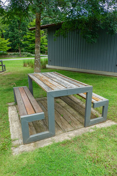 Wooden Bench in park,chairs and table in countryside,outdoor seating cafe or restaurant,Neat paved patio with sitting area,small garden in farm.