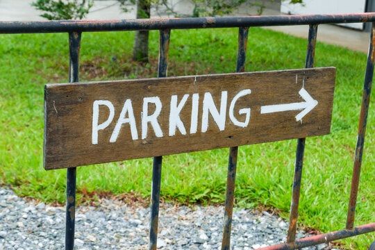 Parking Lot Sign in park,Car Park sign background with white arrow direction,text,streetsign in countryside,public car park information board,vehicle parking area sign concept.