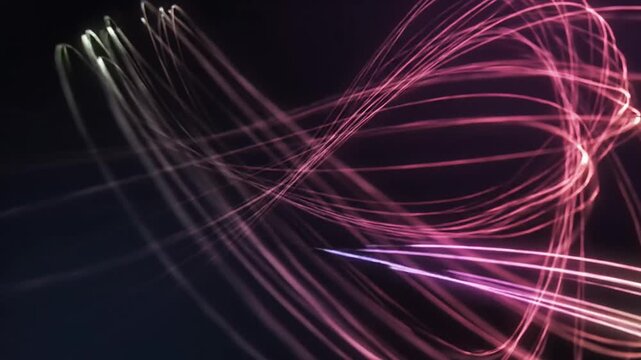 Abstract animation of luminous gradient light lines in various patterns showcasing vibrant movement and flow on dark background