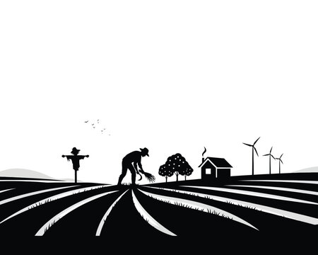 Farmer tending rows in rural field with wind turbines