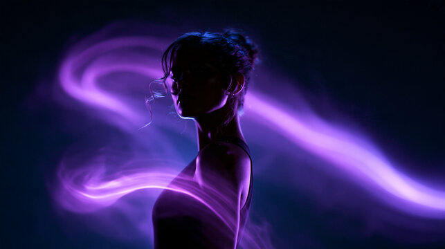 Silhouette of Woman Surrounded by Purple Light Trails
