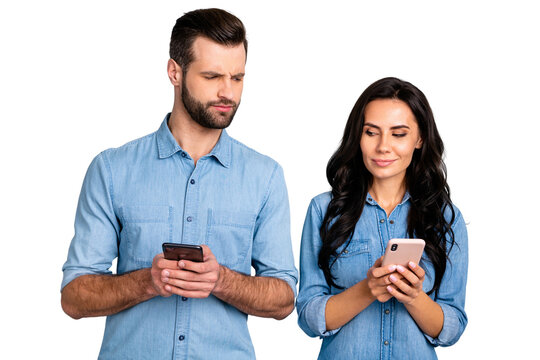 Close up photo wondered she her he him his lady guy telephone smart phone hands arms reader doubt unsure uncertain loyalty wear casual jeans denim shirts outfit clothes isolated light grey background
