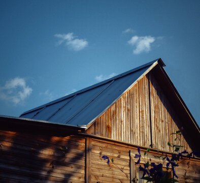 Roof and part of facade of an old Russian wooden village house building