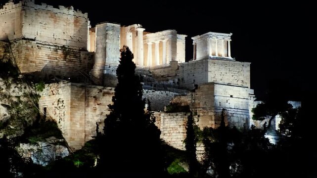 Night view of the illuminated Propylaea and the Temple of Athena Nike on the Acropolis in Athens, Greece
