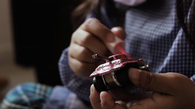 Little Girl In Argentine Kindergarten Uniform Painting Toy Tank - 4K