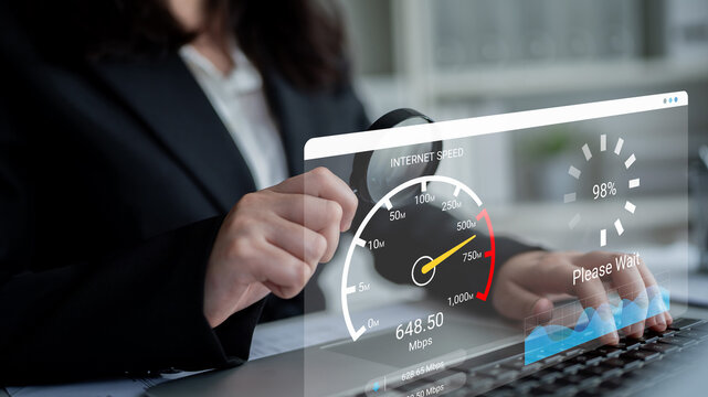 Busy professional checks internet speed on laptop, displaying speed test results while waiting for updates. Perfect for technology and business-related themes. Ledger