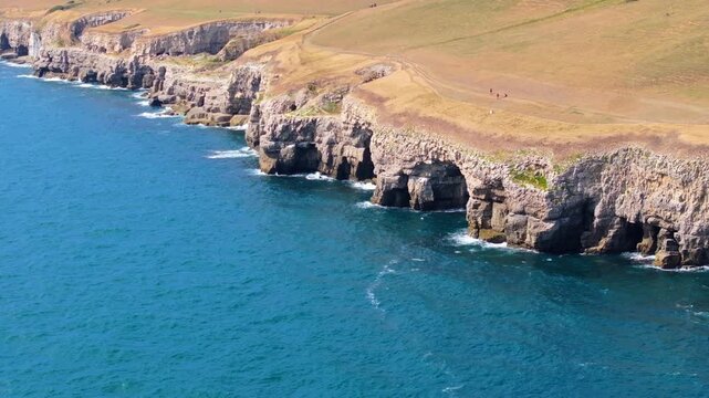Aerial shot of the cliffs, caves and quarries along the Jurassic coast near Dancing Ledge, Dorset, UK
