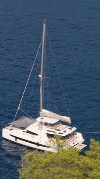 Vertical Video of Catamaran Anchored Near Shore